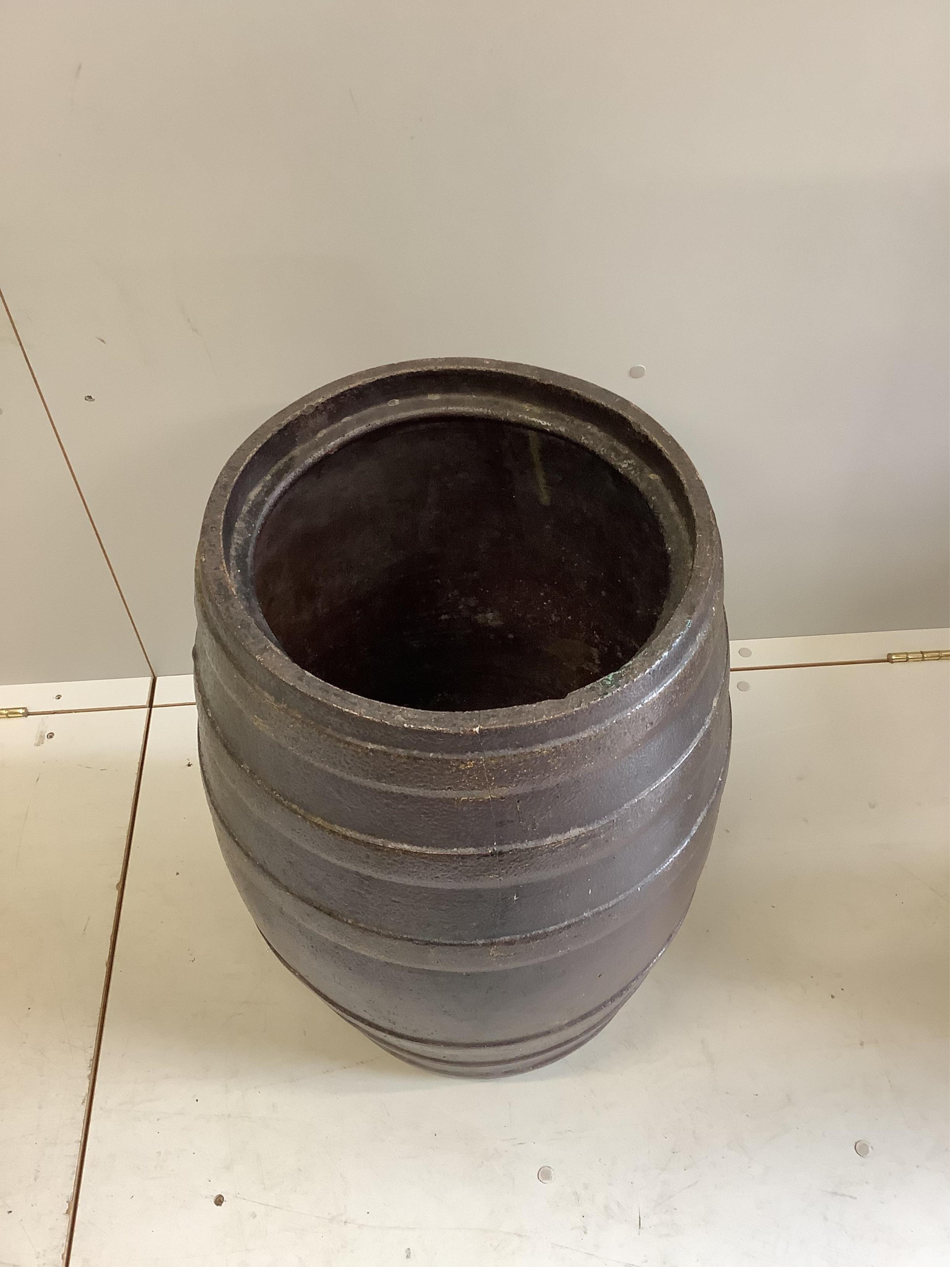 A Victorian salt glazed earthenware barrel with associated wood cover, diameter 40cm, height 73cm. Condition - good